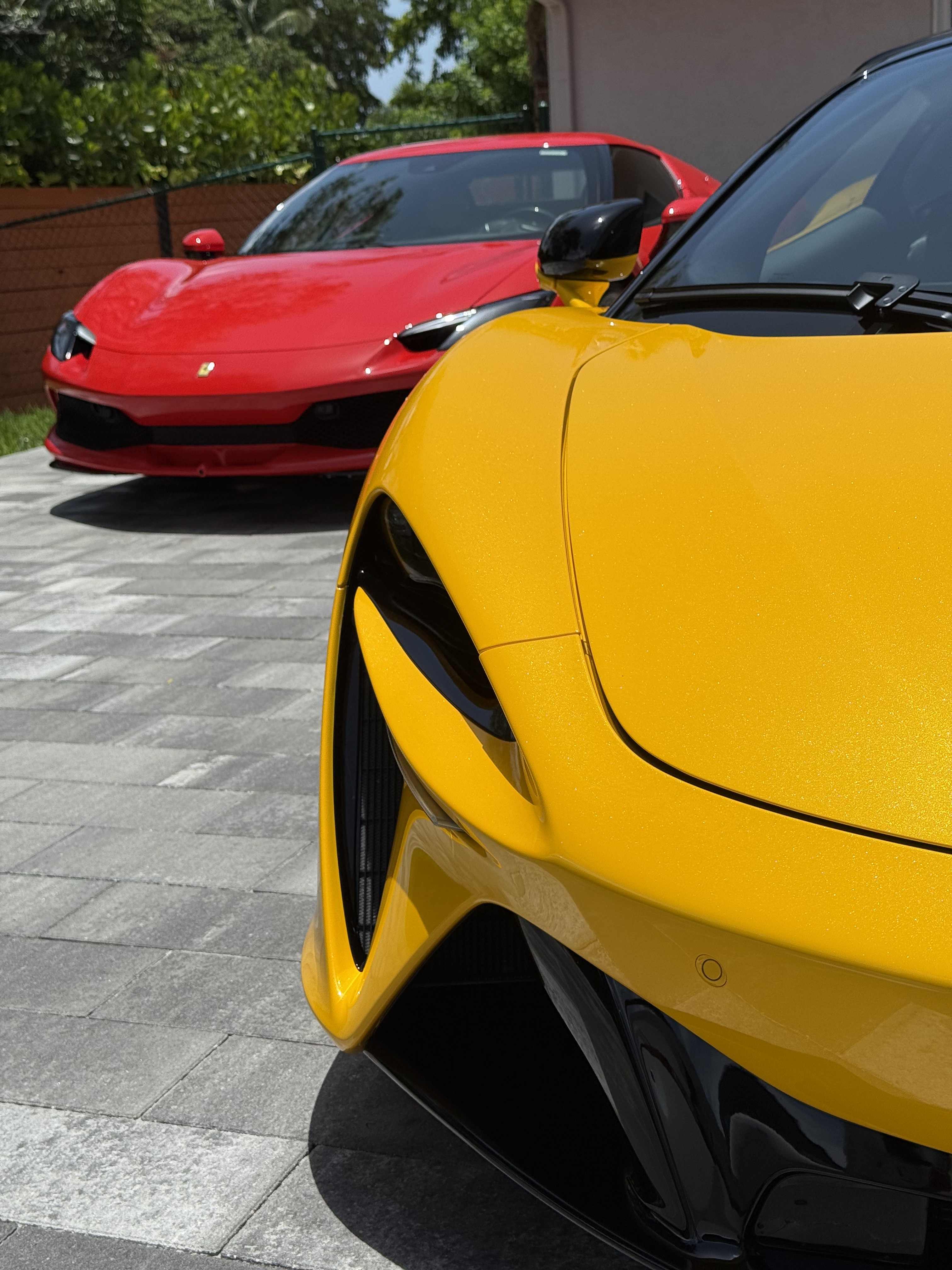 Yellow McLaren and red Ferrari detailed side by side